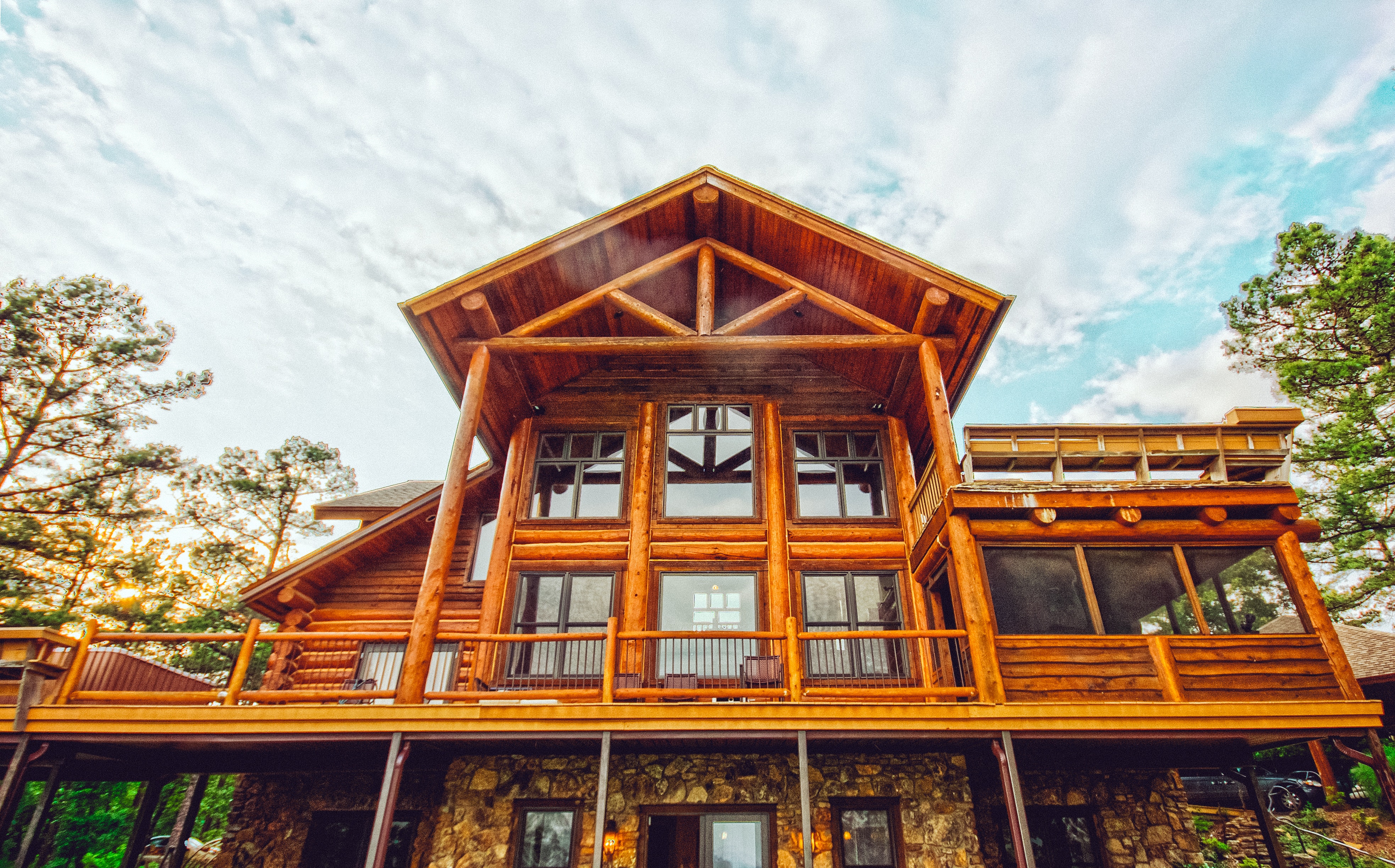 a luxury cottage made of wood with several large windows